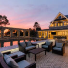Patio lounge at sunset with stone arch colonnade by Victor & Sons Masonry in Stoneyard Boston Blend Round 140 Photo by Matt McNamara.