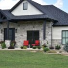 Grayson Rustic Ashlar thin veneer limestone installed as home exterior siding and porch columns on a modern farmhouse