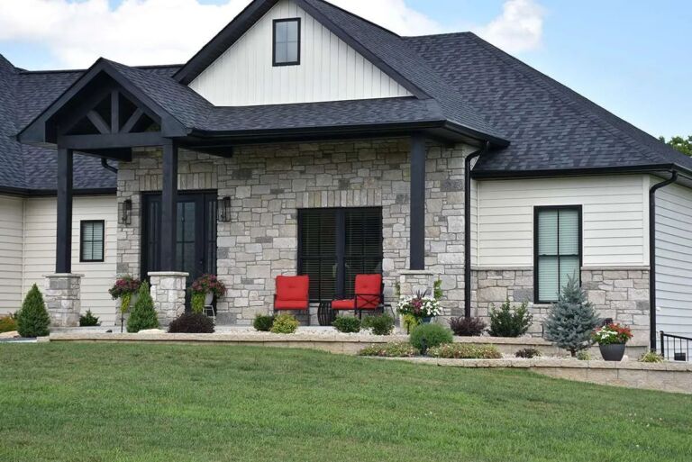 Grayson Rustic Ashlar thin veneer limestone installed as home exterior siding and porch columns on a modern farmhouse