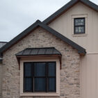 Grayson Stacked Stone thin veneer limestone installed as home exterior siding and porch columns on a transitional farmhouse