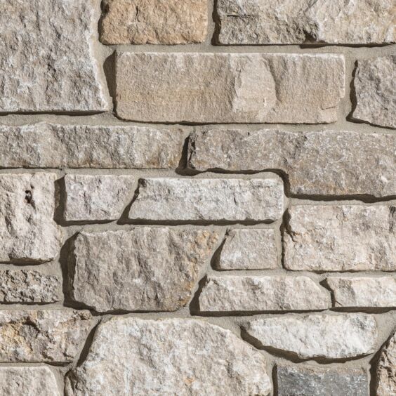 VTWKGYF Grayson Stacked Stone Thin Veneer Limestone Close Up Grayson Stacked Stone thin veneer limestone close-up showing cream, beige, and grey tones with mortar joints