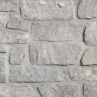 Aspen Ridge Stacked Stone thin veneer limestone close-up showing large-format creamy grey pieces with mortar joints
